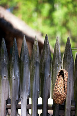 Bast sandal from the bark of a tree on a fence