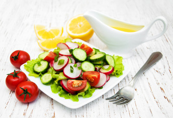 Spring salad with tomato, cucumbers and radish