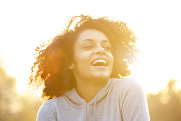 Naklejka premium Happy african american girl laughing outdoors