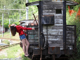 Beautiful young woman and vintage train