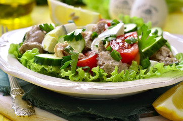 Vegetable salad with eggs and cod liver.