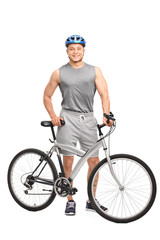 Man with a blue helmet posing behind his bike