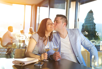 Beautiful young couple drinking wine in a bar