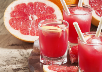 Pink grapefruit drink with pulp, selective focus
