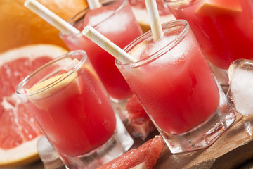 Pink grapefruit drink with pulp, selective focus