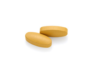 Vitamin C pills on white background