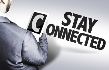Executive holding a tablet pc with text: Stay Connected