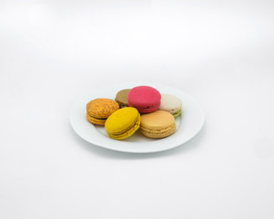 Colorful macarons on white background