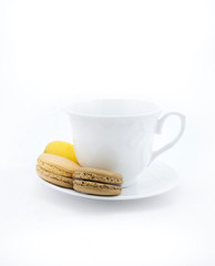 Colorful macarons with white cup and plate
