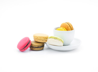Colorful macarons with white cup and plate