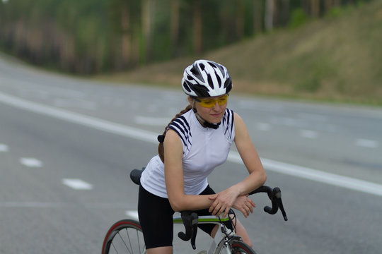 cyclist on the road, the girl with bike