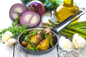     Delicious baked young potatoes on a wooden background 