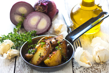     Delicious baked young potatoes on a wooden background 