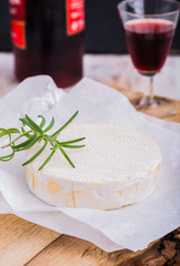 Traditional Camembert and red wine on white paper