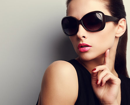 Elegant chic female model in fashion sunglasses posing