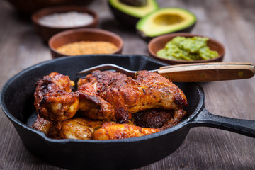Grilled chicken legs and wings with guacamole
