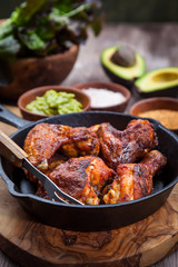Grilled chicken legs and wings with guacamole