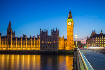 Fototapeta na wymiar London, United Kingdom - Illuminated Big Ben with the Parliament building taken from Westminster bridge at blue hour with clear blue sky at dusk