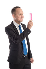 Bald man looking a comb in his hand on white background