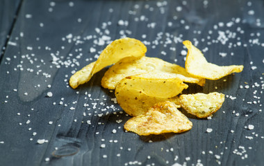 Potato chips and sprinkled salt, selective focus