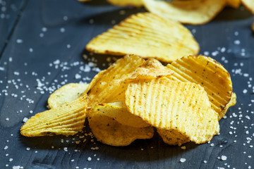Potato chips and sprinkled salt, selective focus