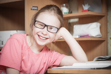 Cute kid girl at home while wearing glasses.