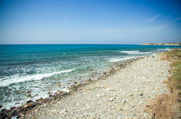 Fototapeta na wymiar Pebble beach and blue water of the Mediterranean Sea. Toned