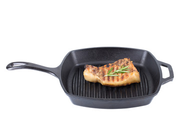 Pork steak with rosemary on the pan isolated on a white backgrou