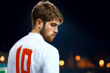 Soccer player on the stadium, night time