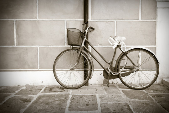 Old bike against the wall - toned image
