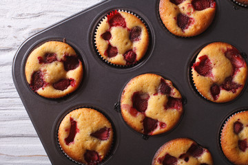 strawberry muffins close-up in baking dish horizontal top view 
