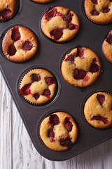 muffins strawberry close up in baking dish. vertical top view