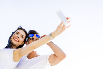 Beautiful young couple taking a selfie on a summer day