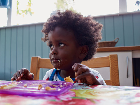 Adorable black African baby eating