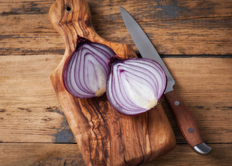 Fresh red onions on a wooden background