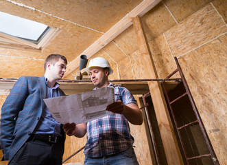 Architect and Foreman Consulting Building Plans