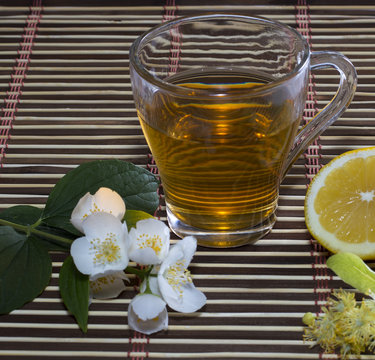 glass of lime tea with a lemon close up