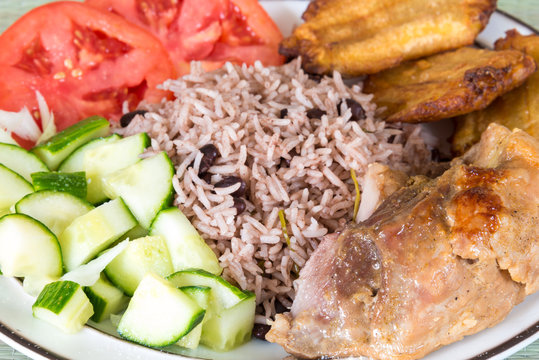 Cuban Cuisine: traditional creole dish with pork,congri,salad and tachinos
