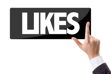 Businessman pressing button with the text: Likes
