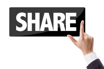 Businessman pressing button with the text: Share