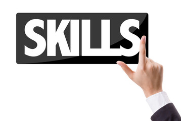 Businessman pressing button with the text: Skills