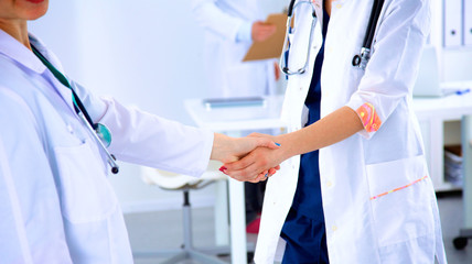 Young medical people handshaking at office
