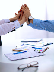 Closeup of business people&amp;#39;s hands making a pile 