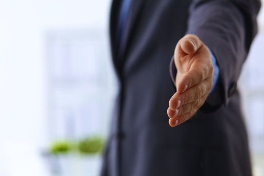Portrait of businessman giving hand for handshake