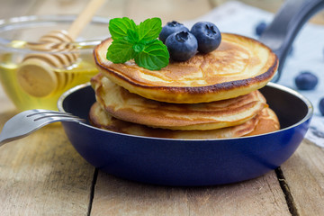 Stack of pancakes with blueberry and honey