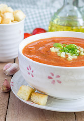 Cold tomato soup gazpacho in a bowl with croutons, closeup
