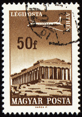 Obraz premium Flying plane above the Athens on post stamp
