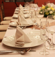 Glasses and plates on table in restaurant