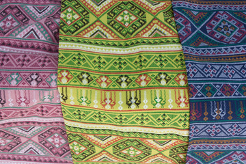 Patterned sarongs sold in the market Thailand.