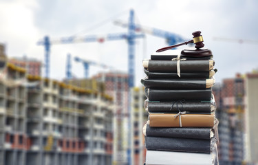 Files with gavel, buildings and cranes